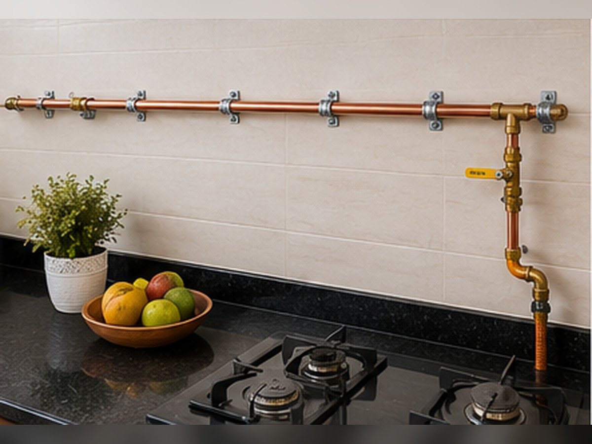 Copper gas line clamped above a kitchen counter, turning down to a hob connection